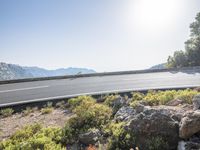 a motorcycle is parked on a scenic road near the mountains in france's south