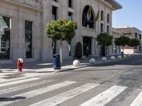 a crosswalk on a city street with buildings around it on a sunny day,