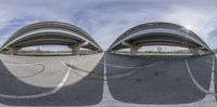 two fish -eye images of street with ramps and arches in the background and a blue sky