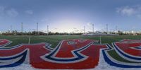 a view of a soccer field with several red, white and blue designs on it