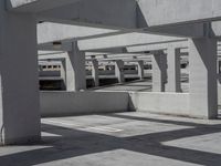 several buildings with concrete roof and flooring in an empty parking lot area on a sunny day