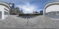 a panorama lens image of a street in front of some buildings and windows looking at a bike