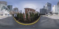 a photograph of a skate park on the side of a street in front of city buildings