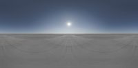 the sun shines brightly above a vast expanse with long, thin, lines of sand covering it