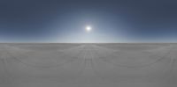 the sun shines brightly above a vast expanse with long, thin, lines of sand covering it