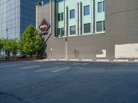 a paved street has been painted light gray, with gray brick walls and concrete edges