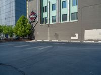 a paved street has been painted light gray, with gray brick walls and concrete edges