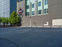 a paved street has been painted light gray, with gray brick walls and concrete edges