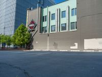 a paved street has been painted light gray, with gray brick walls and concrete edges