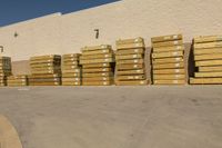 a large group of cardboard boxes are sitting in front of a building on the ground