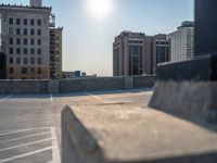 several large empty parking spaces in the city with buildings nearby in front of them -