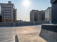 several large empty parking spaces in the city with buildings nearby in front of them -