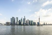 a large city with tall buildings is in the middle of water with the skyline visible