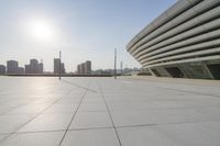 a paved courtyard overlooking the buildings of the city on a sunny day in asia or india