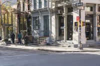an intersection with buildings and a street light on a sunny day in the city,