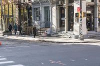 an intersection with buildings and a street light on a sunny day in the city,