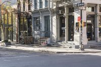 an intersection with buildings and a street light on a sunny day in the city,
