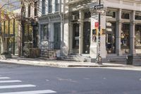 an intersection with buildings and a street light on a sunny day in the city,