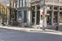 an intersection with buildings and a street light on a sunny day in the city,