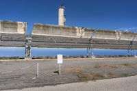 an abandoned coal fired structure with sign saying no smoking on it with blue sky in the background