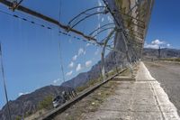 the reflection of the mountain is reflected in a window of the fence outside the building