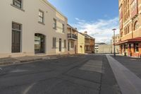 a street with buildings and people in it and no cars on the sidewalks and an empty sidewalk