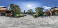 the panorama shows two circular homes that are close together on a sunny day in the city