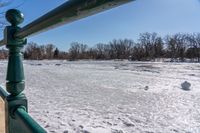 an image of the frozen river in winter time on a sunny day, looking out to the water