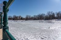 an image of the frozen river in winter time on a sunny day, looking out to the water