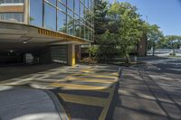 the yellow and gray markings are painted on a parking lot in an apartment building on a sunny day