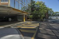 the yellow and gray markings are painted on a parking lot in an apartment building on a sunny day