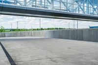 an empty parking area outside a large building that is under construction with windows on top