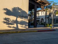 street view of sunnyhill restaurant from across the road with building and trees on either side