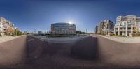 a panoramic photo with buildings and traffic lights on a sunny day in an urban setting