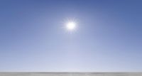 the sun is shining brightly on a clear day of snow - covered ground in a field