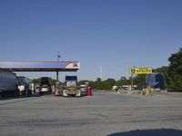 trucks lined up at the gas station waiting to fill up passengers, which is very small
