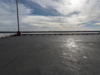 the dock and the water from which one is parked on the pier, with a bird flying in the distance