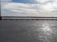 the dock and the water from which one is parked on the pier, with a bird flying in the distance