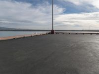 the dock and the water from which one is parked on the pier, with a bird flying in the distance