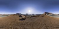 a fish eye view of the desert of an urban area with some mountains in the background