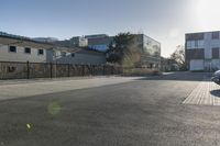 a car parked on a side walk with buildings in the background from outside of a building