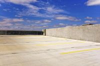 a parking lot with concrete walls and concrete steps in the parking lot and a building on one wall