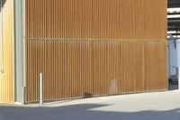 two bikes are parked next to a building made out of wood slats and white walls