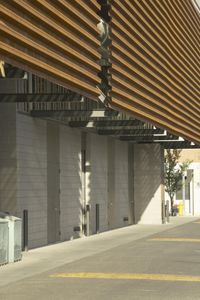 two bikes are parked next to a building made out of wood slats and white walls