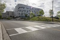 a large building with many designs on it's side in front of a road