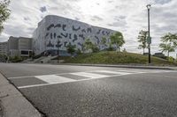 a large building with many designs on it's side in front of a road