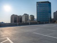 several large empty parking spaces in the city with buildings nearby in front of them -