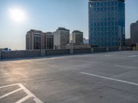 several large empty parking spaces in the city with buildings nearby in front of them -