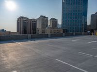 several large empty parking spaces in the city with buildings nearby in front of them -