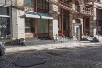 a street scene with old buildings and bicycles parked on the sidewalk, on a sunny day